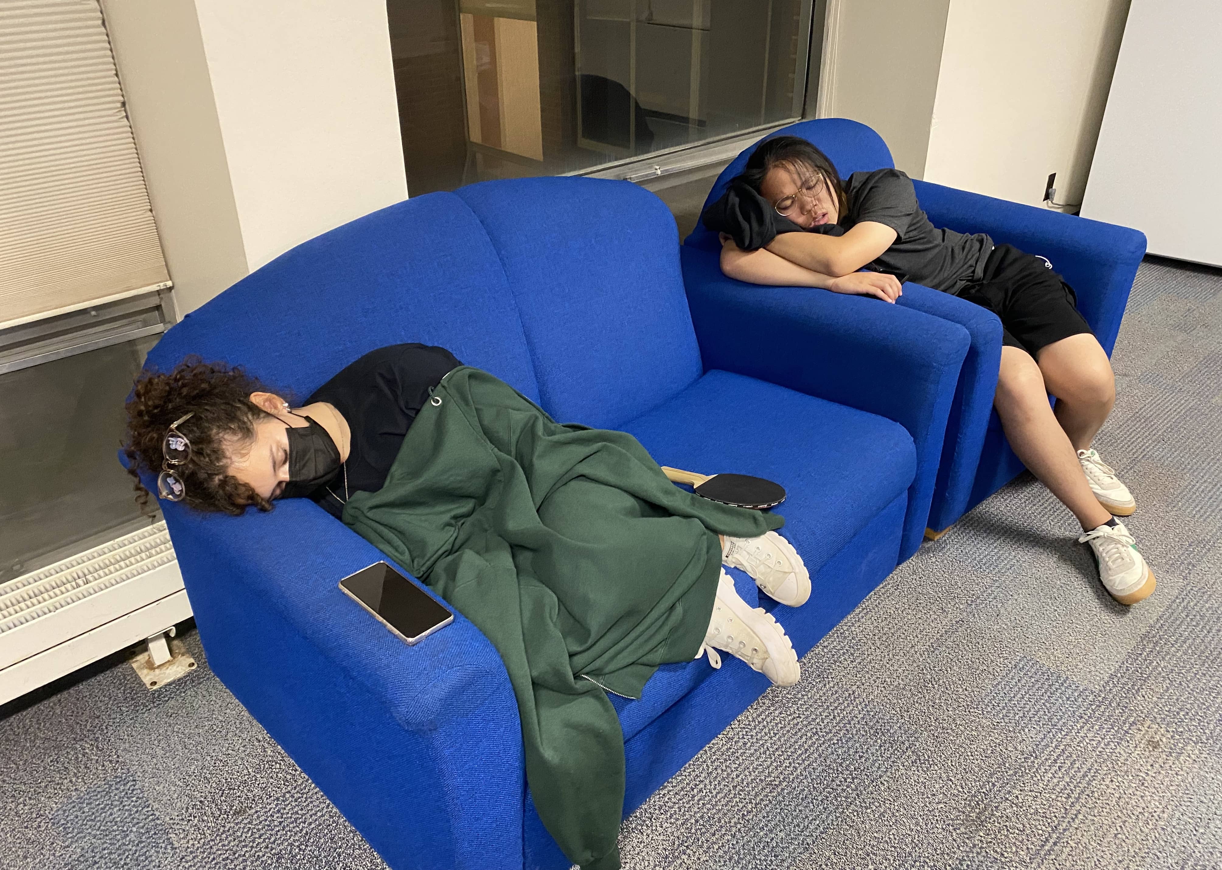 Sarah and Simon sleep on the couches in HILC